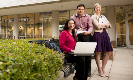 Three TCU Neeley MBA students sit outside the business building
