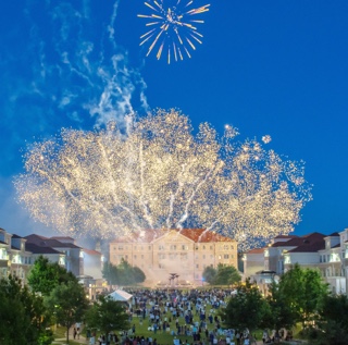 Fireworks exploding in the night sky over the campus commons Scharbauer Hall