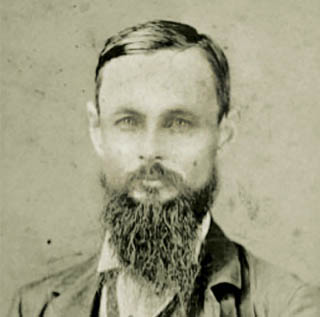 A black and white portrait of TCU founder Randolph Clark, a middle-aged bearded man, in 1874.