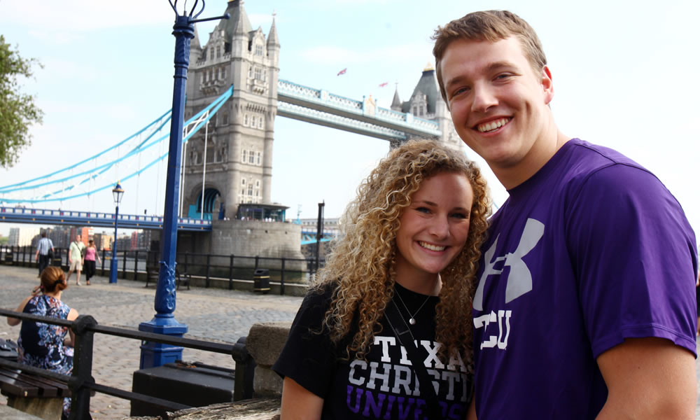 A female and male student standing in front of Tower Bridge in London