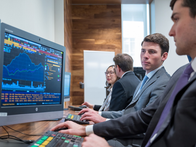 A group of students reviews statistics in a computer lab