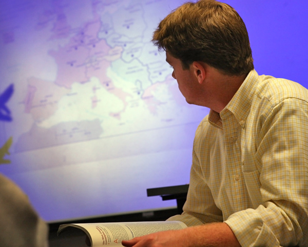 Student with map behind him