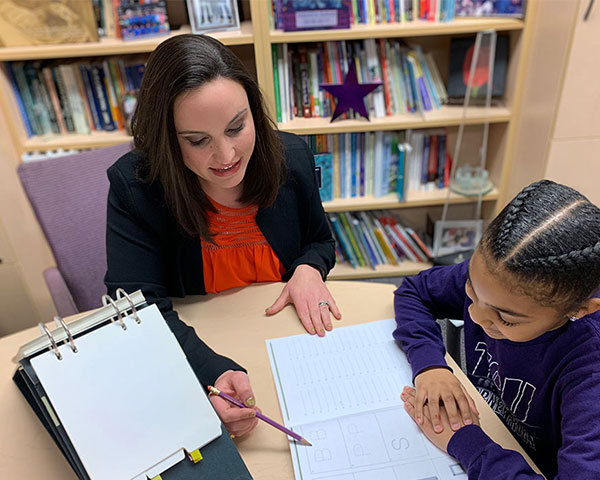 Teacher working one-on-one with young student