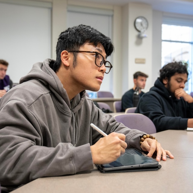 Student taking notes on iPad