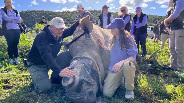 TCU faculty and students with rhino