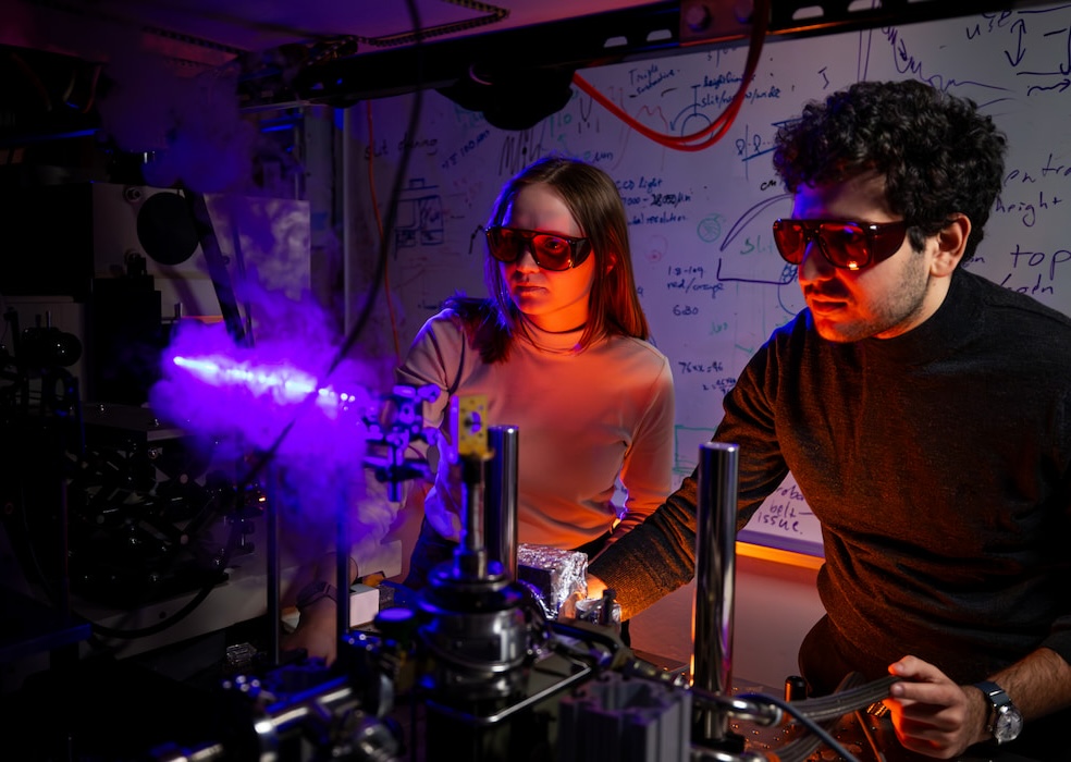 Two students working with a laser