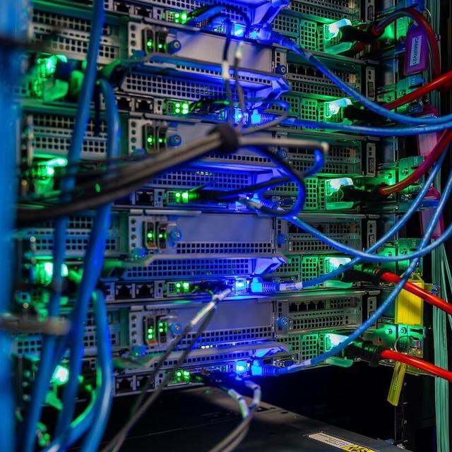 Detail of an AI server rack with lights and cables