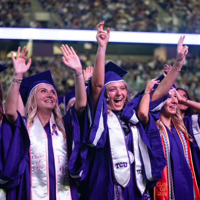 TCU Graduates celebrating at commencement ceremony